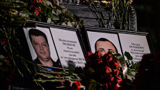 Портреты погибших в Сирии подполковника Олега Пешкова и матроса Александра Позынича. Архивное фото Портреты погибших в Сирии подполковника Олега Пешкова и матроса Александра Позынича. Архивное фото