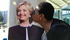 A resident of Los Angeles kisses portrait of Hillary Clinton.  Archival photo