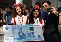 Мужчина фотографируется с образцом банкноты в 200 рублей на международном инвестиционном форуме Сочи 2016 Мужчина фотографируется с образцом банкноты в 200 рублей на международном инвестиционном форуме Сочи 2016