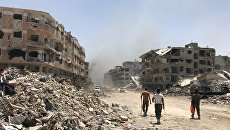 Разрушенные дома в освобожденном лагере палестинских беженцев Ярмук на юге Дамаска. Архивное фото Разрушенные дома в освобожденном лагере палестинских беженцев Ярмук на юге Дамаска. Архивное фото