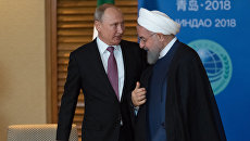 Владимир Путин и президент Ирана Хасан Роухани во время встречи на полях саммита ШОС. 9 июня 2018 Владимир Путин и президент Ирана Хасан Роухани во время встречи на полях саммита ШОС. 9 июня 2018