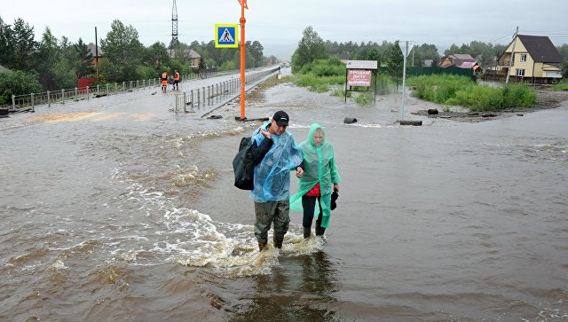 Местные жители на затопленной в результате паводка улице в Чите. Архивное фото