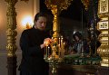 Монах зажигает лампады у раки с мощами святых Сергия и Германа в день празднования памяти преподобных Сергия и Германа Валаамских Монах зажигает лампады у раки с мощами святых Сергия и Германа в день празднования памяти преподобных Сергия и Германа Валаамских